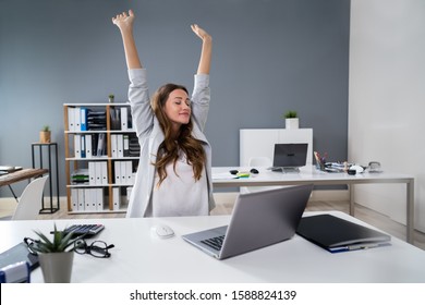 Young Businesswoman Stretching Her Arms At Desk - Shutterstock ID 1588824139