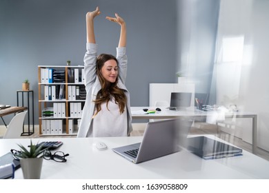 Young Businesswoman Stretching Her Arms At Desk - Shutterstock ID 1639058809
