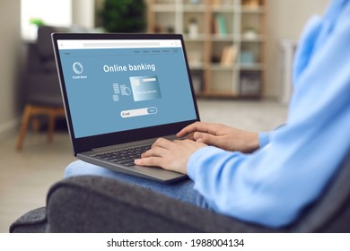 Young Businesswoman Or Student Girl Sitting In Armchair At Home Using Laptop To Visit Online Bank Website And Open Personal Or Business Account. Hands And Computer Closeup. Safe Money Transfer Concept