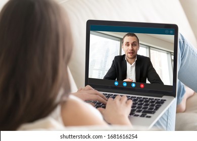 Young businesswoman talk chat with financial consultant on video call on laptop, female employee or client speak with male business partner use webcam computer conference, online consultation concept