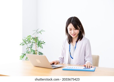 A Young Businesswoman Teleworking And Participating In A Remote Meeting