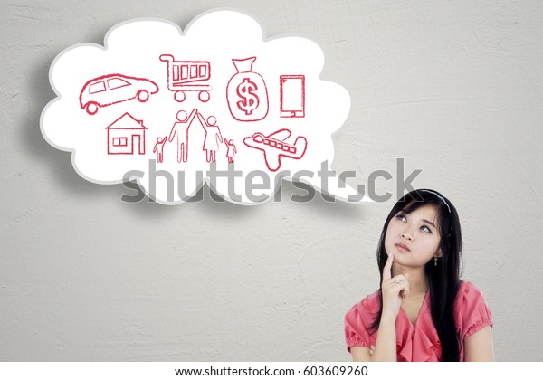 Young businesswoman thinks her dream while looking\
at cloud speech