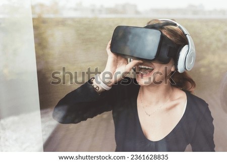 Young businesswoman using 3D viewer - video gam, vr reality, augmented reality concept