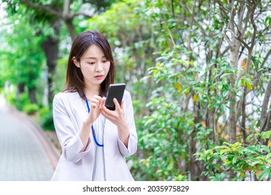 A young businesswoman using a map application - Powered by Shutterstock