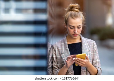 Young businesswoman using a mobile phone in the city
 - Shutterstock ID 1817766644
