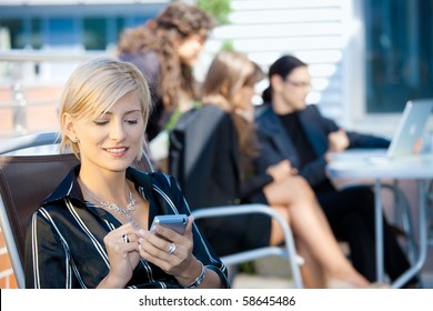 Young Businesswoman Using Smart Mobile Phone, Outside Office Building.