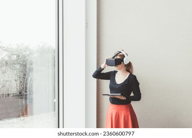 Young businesswoman using tablet 3D viewer exploring immersive metaverse
