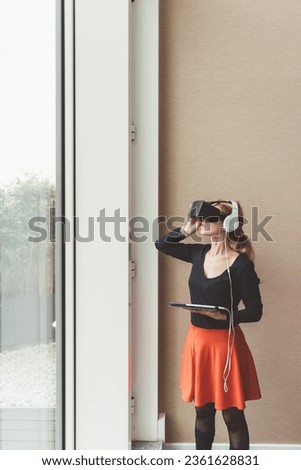 Young businesswoman using tablet 3D viewer - wereable technology, user experience, augmented reality