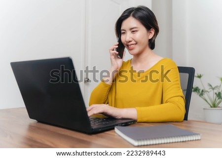 A young businesswoman is very happy after checking her email through her laptop.