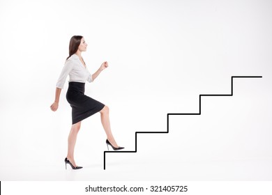 Young businesswoman walking up on  steps of the career ladder