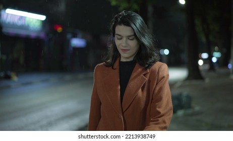 Young Businesswoman Walking In Street At Night During Rain Drizzle. Carefree Millennial Adult Girl Walks Alone In City Downtown