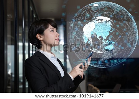 Young businesswoman watching GUI of world map. GLobal business concept.