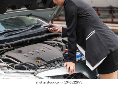 Young businesswoman whose car breakdown uses mobile phone to call for roadside assistance service. Travel and transportation vehicle problem. - Shutterstock ID 1348522973