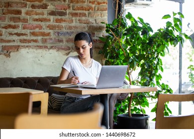 Young businesswoman is working in a cafeteria in her break.Woman taking a break. Enjoying work from coffee shop. Doing Business From coffee shop. - Powered by Shutterstock