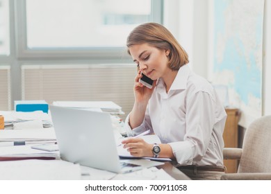 Young Businesswoman Working At The Office And Talking On The Phone