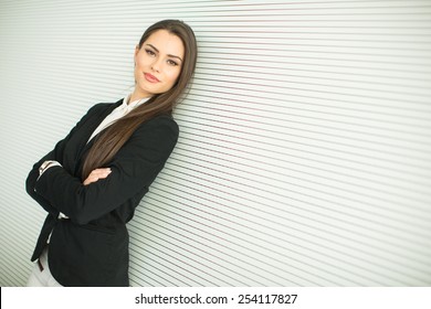 Young Bussiness Woman By The Grey Wall