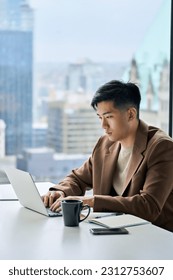 Young busy Asian business man executive working on financial strategy on laptop at corporate office. Professional Japanese businessman manager using computer technology sitting at table, vertical. - Shutterstock ID 2312753607