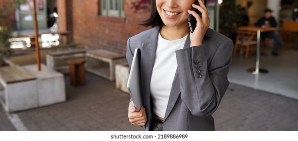 Young Busy Elegant Business Woman Client Manager, Retail Sales Professional, Businesswoman Executive Wearing Suit Talking On The Phone Making Mobile Business Call Standing Outdoors, Close Up.