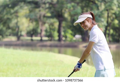 Young Caddy Playing Golf In The Lawn In The City Center. Hold The Golf Clubs, Show The Victory Received In The Game. Use For Background And Design.