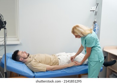 Young Calm Man Lying In Neurologist Office