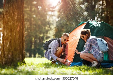 Young campers setting up the tent at the forest. - Powered by Shutterstock