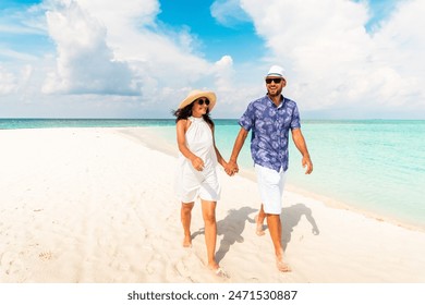 Young carefree caucasian couple woman and man hold hands smile in love walking in tropical white sand beach on honeymoon in Fulidhoo island. Maldives vacation holidays concept - Powered by Shutterstock