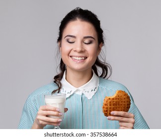 Young Carefree Woman Smiling With Glass Of Milk And Biscuit,  She Has Closed Eyes In Pleasure