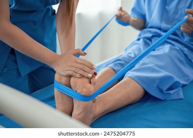 Young Caregiver Assisting Elderly Patient with Physical Therapy Exercises in a Healthcare Setting - Powered by Shutterstock