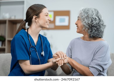 young caregiver assists her elderly woman patient at a nursing home. senior woman is assisted by a nurse at home. - Powered by Shutterstock