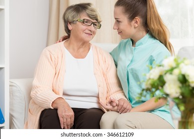 Young Caregiver Providing Care And Support In Rest Home