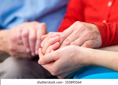 Young Carer Giving Helping Hands For Elderly Woman