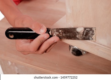 Young carpenter in work clothes  using wood filler in finishing work  for sofa server project isolated on white background - Shutterstock ID 1459772252