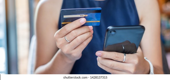 Young Casual Business Woman Holding Credit Card And Using Touchscreen Smartphone For Online Shopping While Making Orders In The Cafe.business, Lifestyle,technology,ecommerce And Online Payment Concept