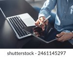 Young casual business woman sitting on the floor using stylus pen and digital tablet, working on laptop computer at home office. Female student online studying, E-learning