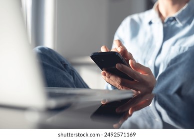 Young casual business woman sitting on the floor using stylus pen and digital tablet, working on laptop computer at home office. Female student online studying, E-learning, work from home - Powered by Shutterstock