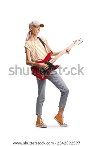Young casual female playing an electric guitar and singing isolated on white background