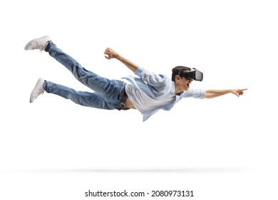 Young Casual Man Flying With A Vr Headset And Pointing Isolated On White Background