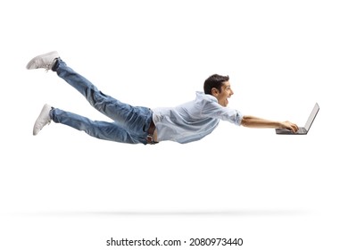 Young casual man flying and working on a laptop computer isolated on white background