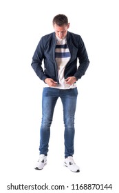 Young Casual Man Getting Dressed Up Holding And Preparing To Zip Up Jacket Fastener. Full Body Isolated On White Background.