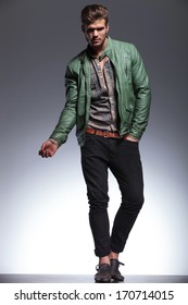 Young Casual Man In Leather Jacket And Jeans Making A Fashion Pose For The Camera