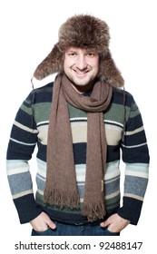 Young Casual Man Portrait With A Russian Hat. Studio Picture Of A Young Man Dressed For Winter