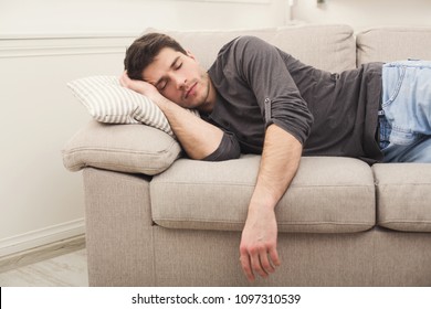 Young Casual Man Sleeping On Couch At Home During Day Time