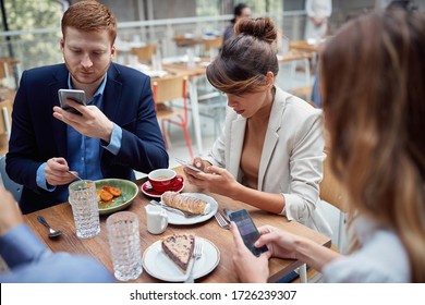 Young Casual People At Business Lunch Texting Message.