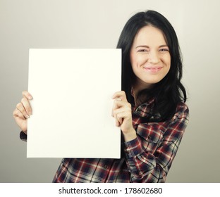 young casual woman happy holding blank sign 