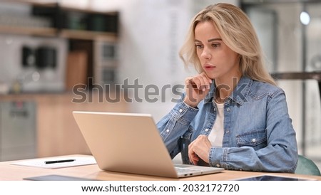 Young Casual Woman with Laptop Thinking at Work