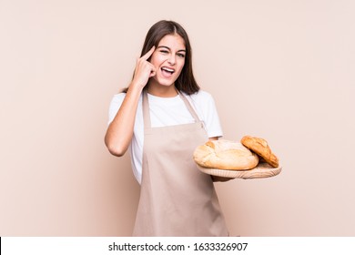Young caucasian baker woman isolated showing a disappointment gesture with forefinger. - Shutterstock ID 1633326907