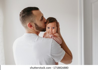 Young Caucasian Bearded Father Carrying Newborn Baby On Shoulder. Male Man Parent  Holding Child Daughter Son In Arms. Authentic Lifestyle Documentary Moment. Single Dad Family Life Concept 