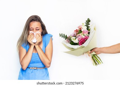 A Young Caucasian Blonde Woman With Allergy To Flowers Holding A Handkerchief. The Girl Sneezes From Allergy Covering The Nose With A Facial Tissue Isolated On White Background