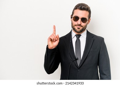 Young Caucasian Bodyguard Man Isolated On White Background Showing Number One With Finger.