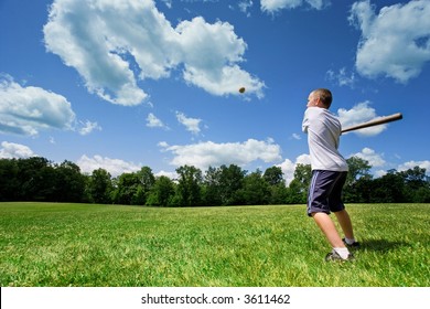 Young Caucasian boy playing baseball in a sunny field on a beautiful summer day. - Powered by Shutterstock